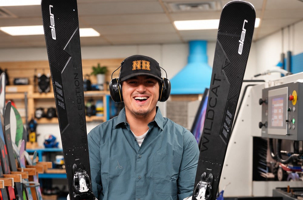 Two ski shop technicians working at a bench