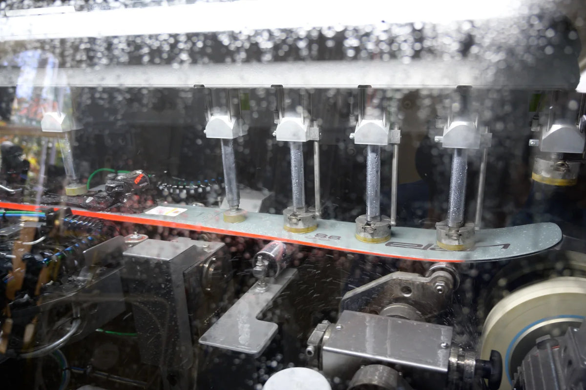 A ski moving through a finishing machine
