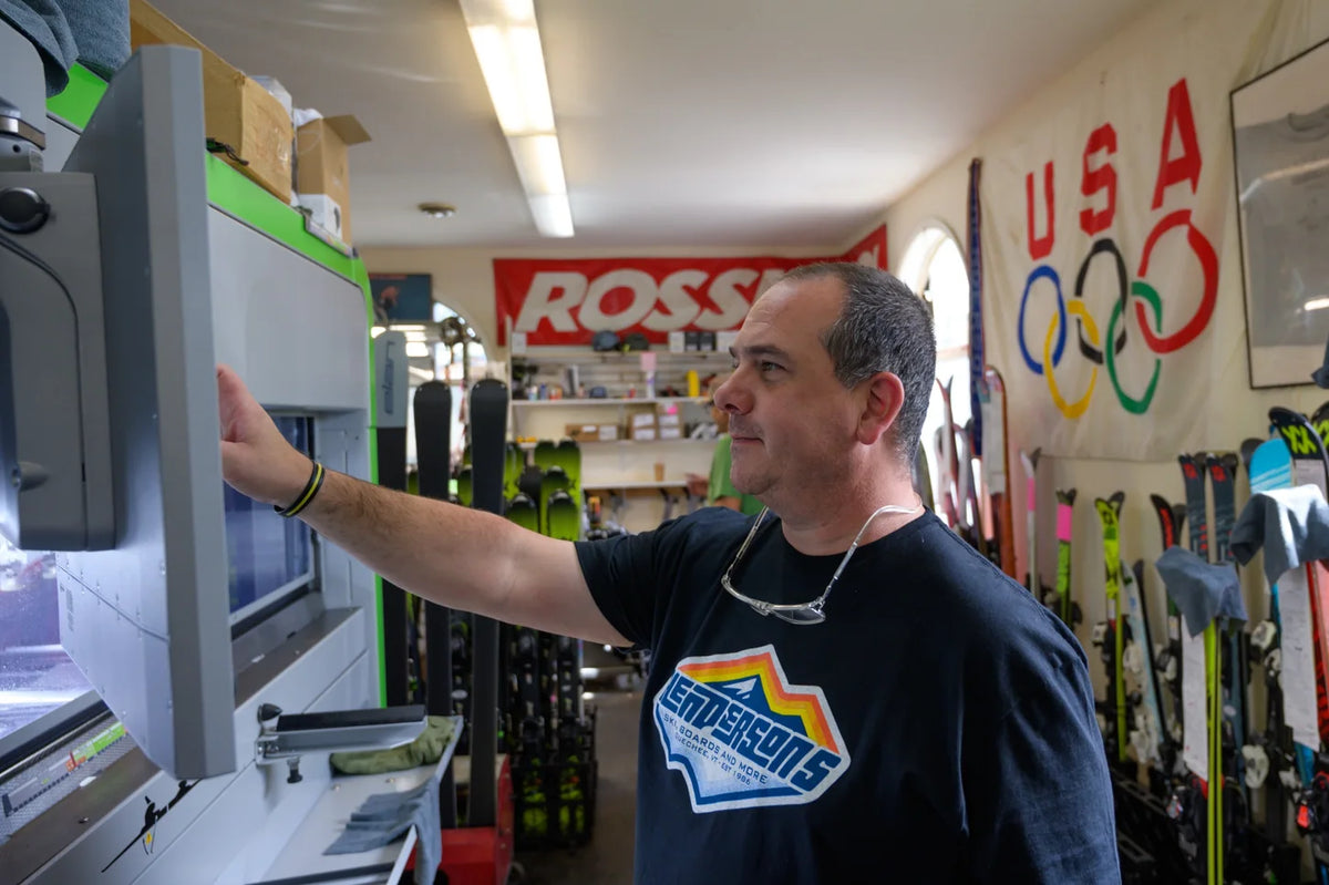 Ski technician using a professional machine